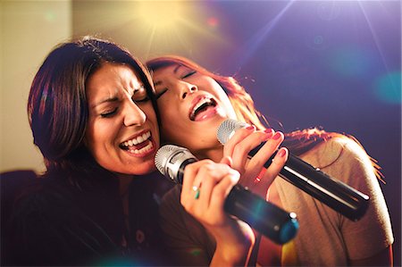 687-07066277
© Masterfile Royalty-Free
Model Release: Yes
Property Release: No
Two women singing karaoke.